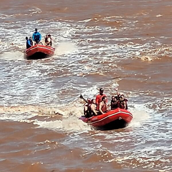 Tidal bore rafting boats riding muddy waves on the Shubenacadie River in Nova Scotia
