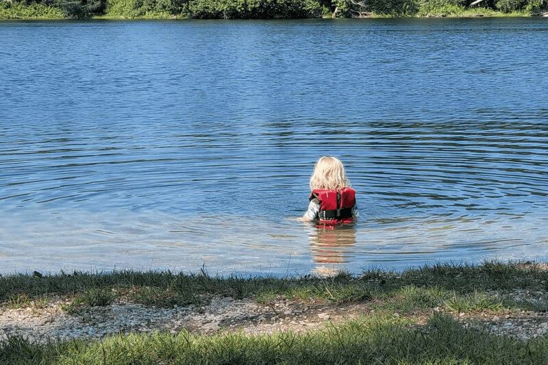 Child swimming at Kempt Quarry near the Minas Basin in Nova Scotia, a popular freshwater swimming spot on a Bay of Fundy day trip near NATURA Wilderness Resort