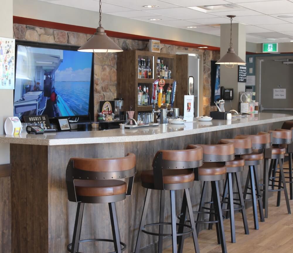 Interior of Snappers Bar &amp; Grill in Kennetcook Nova Scotia with bar seating and local beer taps.